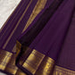 Deep purple Zari Kattam Kanjivaram silk saree on banana leaf showing all-over gold check body and Maanga Mayil gold zari border — Idam Living