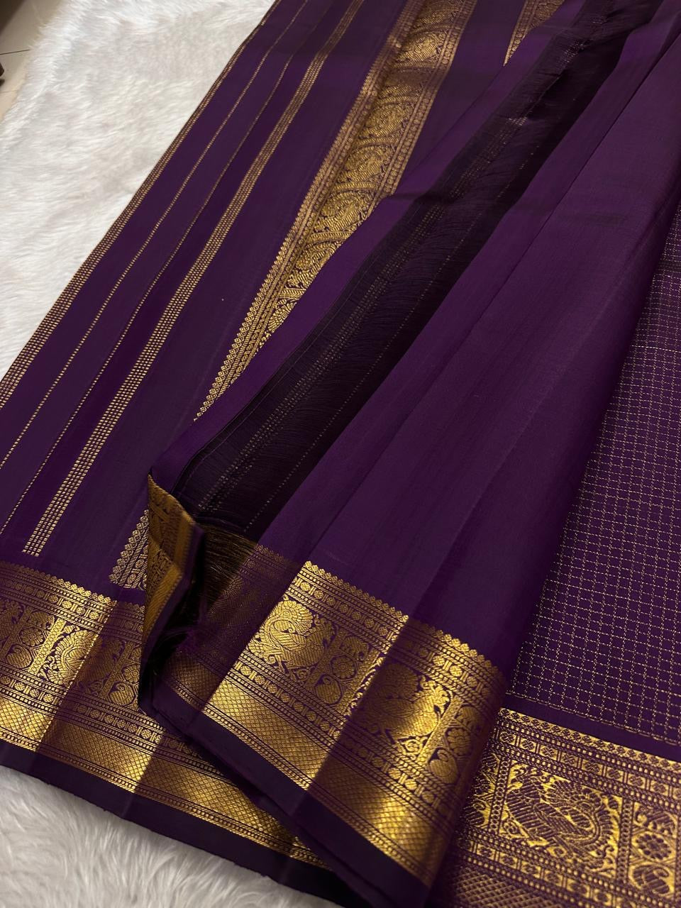 Deep purple Zari Kattam Kanjivaram silk saree on banana leaf showing all-over gold check body and Maanga Mayil gold zari border — Idam Living