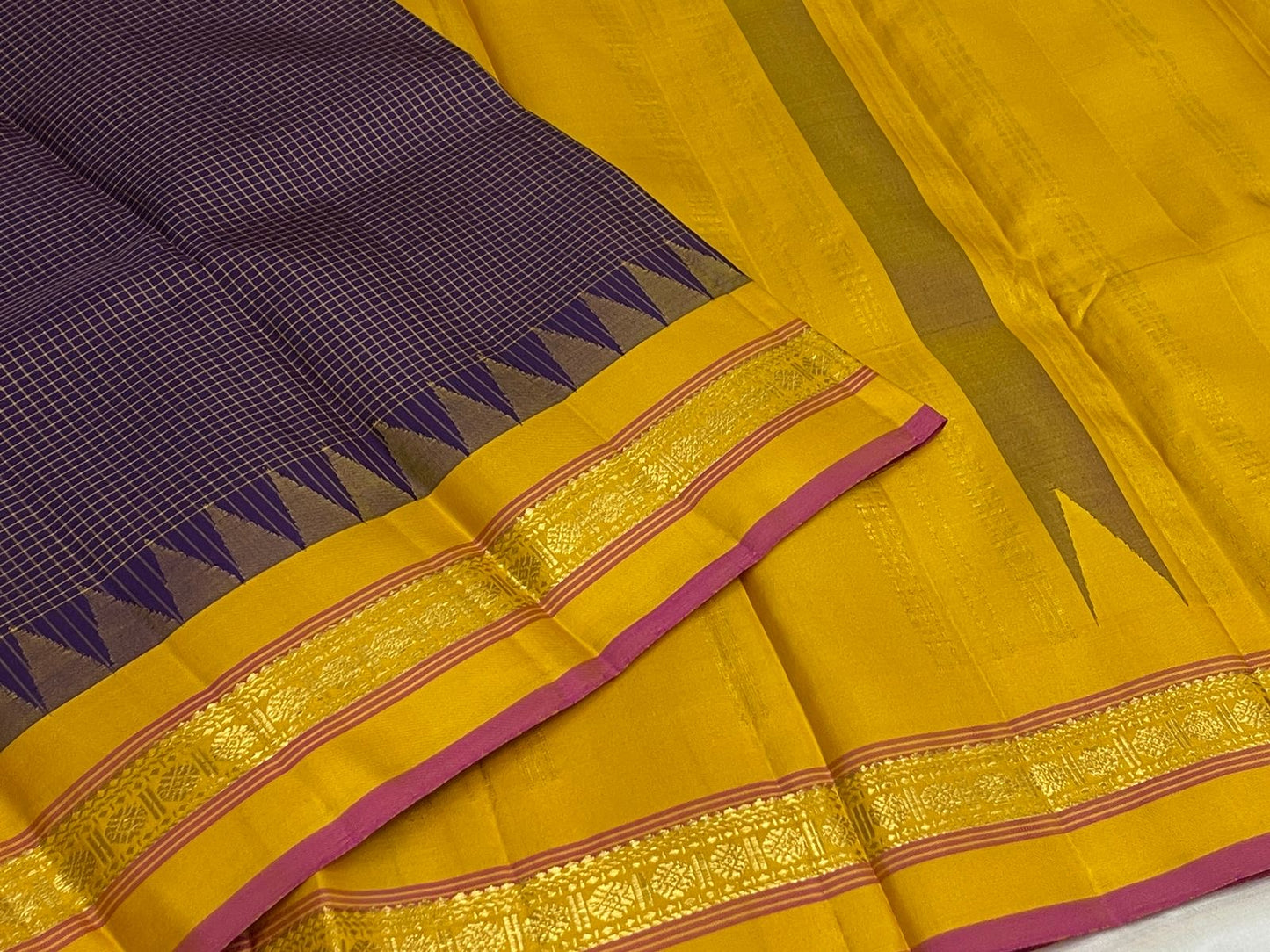 Deep Purple Zari Kattam saree laid flat showing the fine gold grid and yellow border