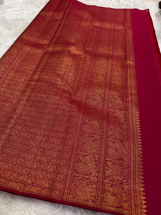 Deep Rani Pink Kanchipuram silk saree body close-up with gold zari floral butta motifs