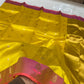 Turmeric yellow Chanderi saree with scattered gold-toned buttas and raspberry pink border with small motifs