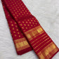 Broad gold zari border detail framed by the vivid Vermilion Pinkish Red silk body