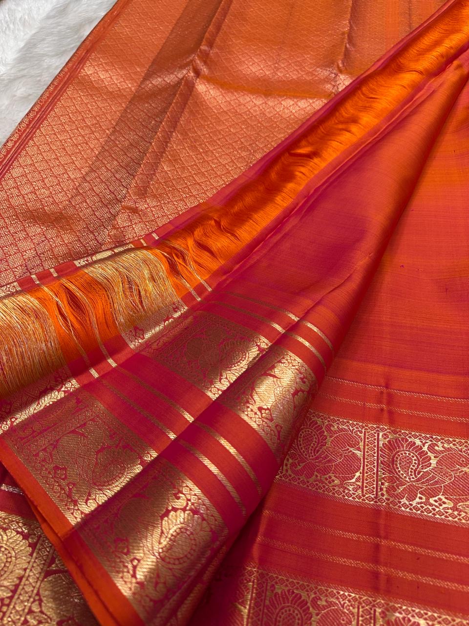 Kanchipattu silk saree in vermilion red with gold border Mayil Butta weave traditional zari detail