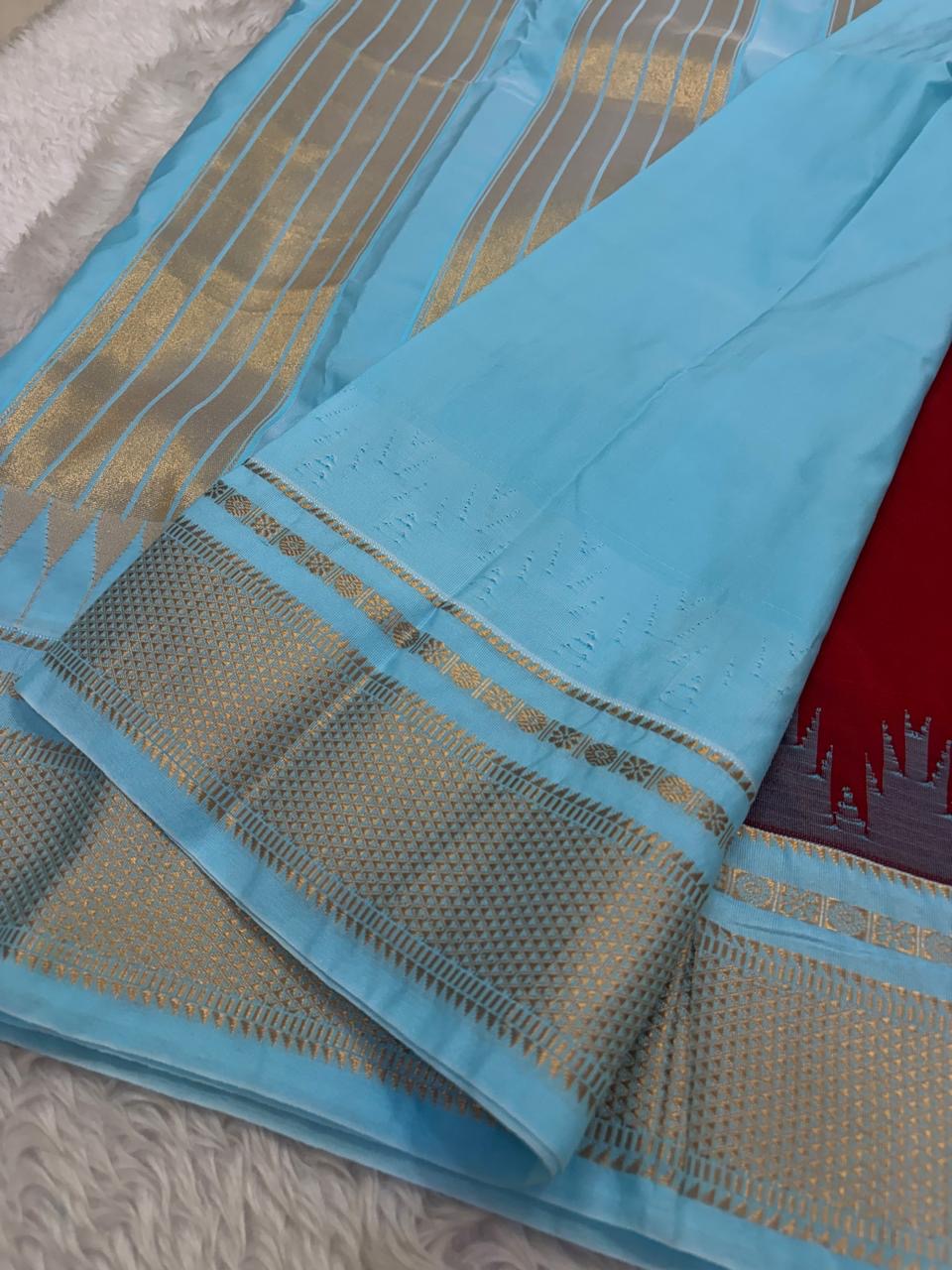 Deep red saree with powder blue and gold border in pure silk