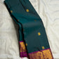 Deep Teal Green Pure Silk Kanchipuram Butta saree with Rani Pink border.