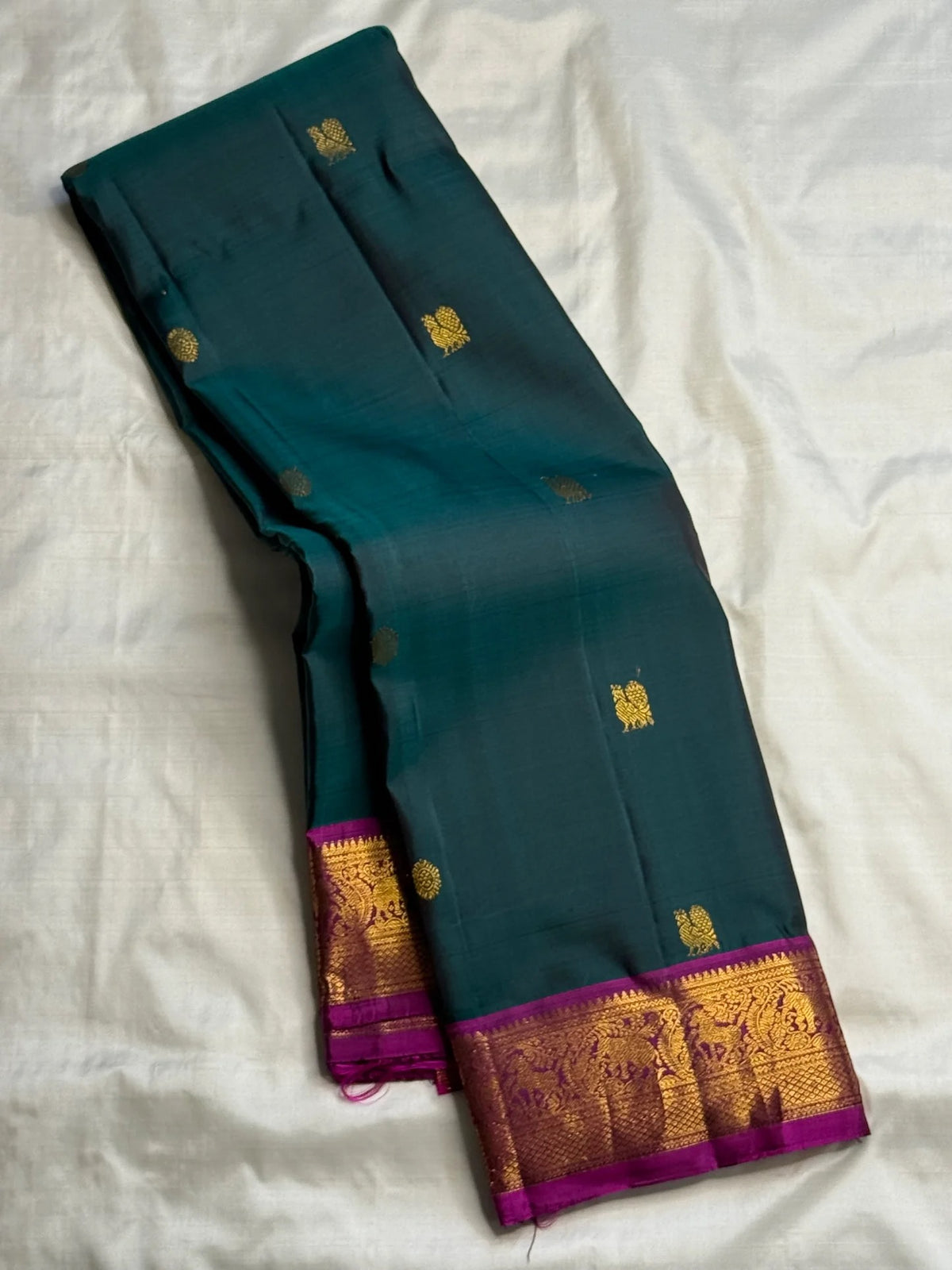 Deep Teal Green Pure Silk Kanchipuram Butta saree with Rani Pink border.