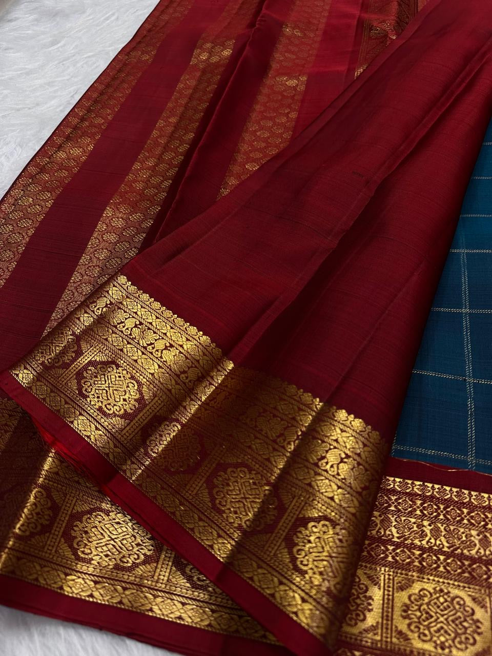 Petite traditional gold zari buttas positioned within the checked Peacock Teal Kanchipuram body.