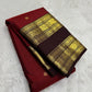 Deep vermilion red Kanjivaram silk saree body close-up with gold zari buttas