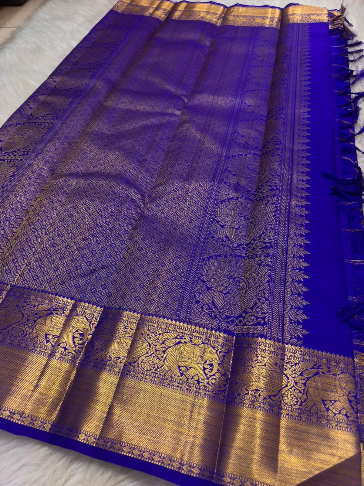 Close-up of antique gold Zari Kattam grid and handwoven Gandaberunda motif on Deep Violet pure silk Kanchipuram saree.