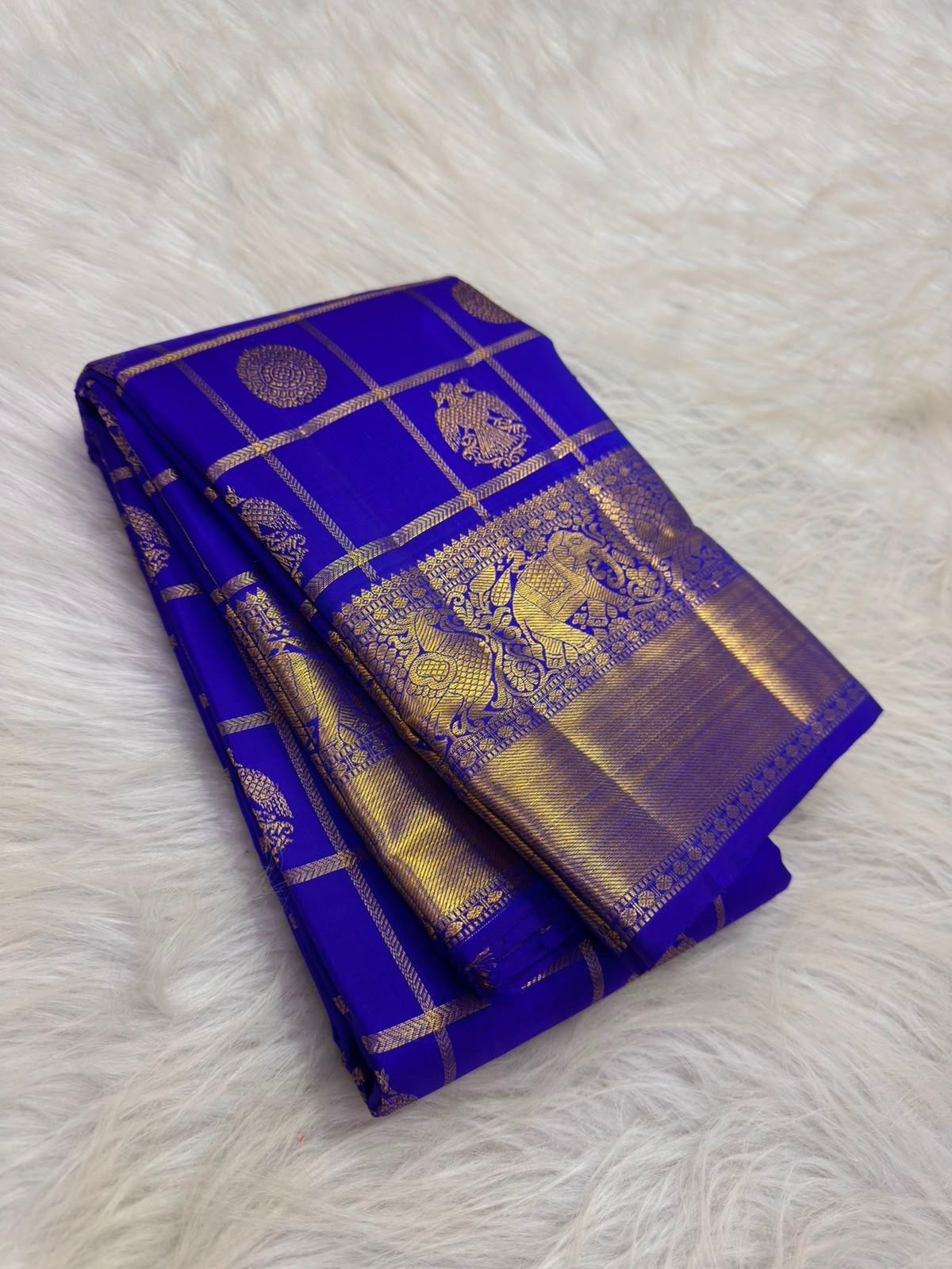 Deep Violet Kanchipuram silk saree with Gandaberunda zari motifs, draped to show the pallu and border detail.