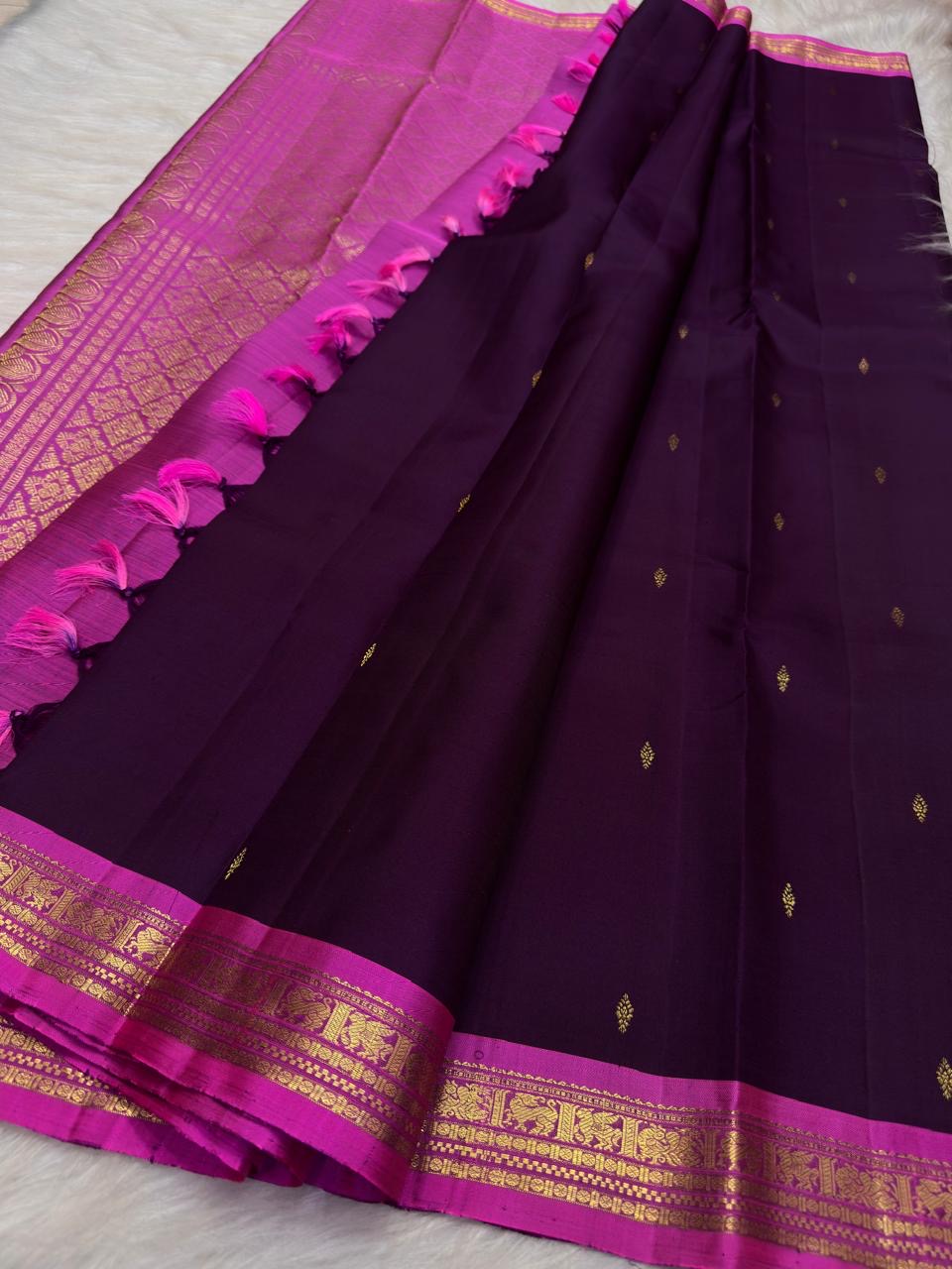 Fuchsia Pink KanchiPattu border with repeated gold zari bird-and-floral panels and geometric registers.