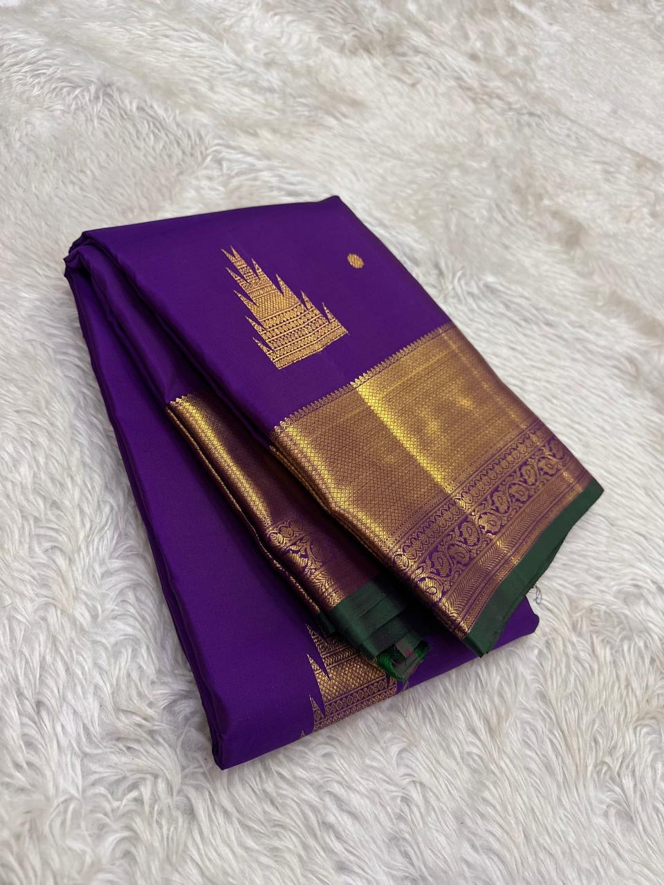 Handwoven Kanchipuram silk saree in jewel-toned violet with intricate zari motifs
