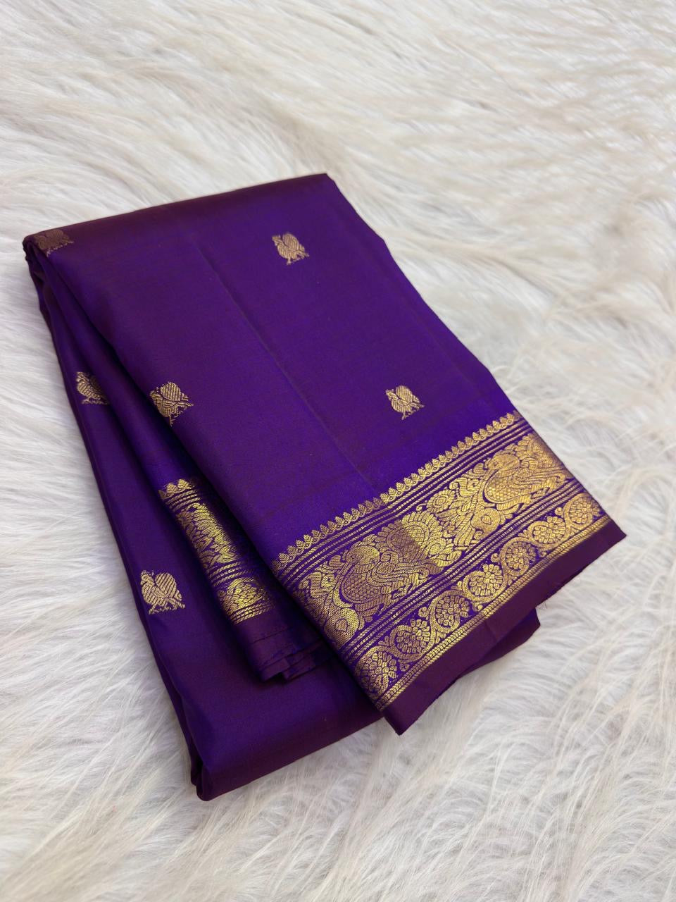 Small Mayil zari border with handwoven peacock motifs on Deep Violet Kanchipuram silk.