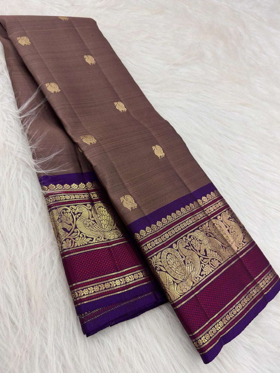 Close view of gold Mayil zari motifs and ornamental foliage on Deep Violet Varisaipet border.