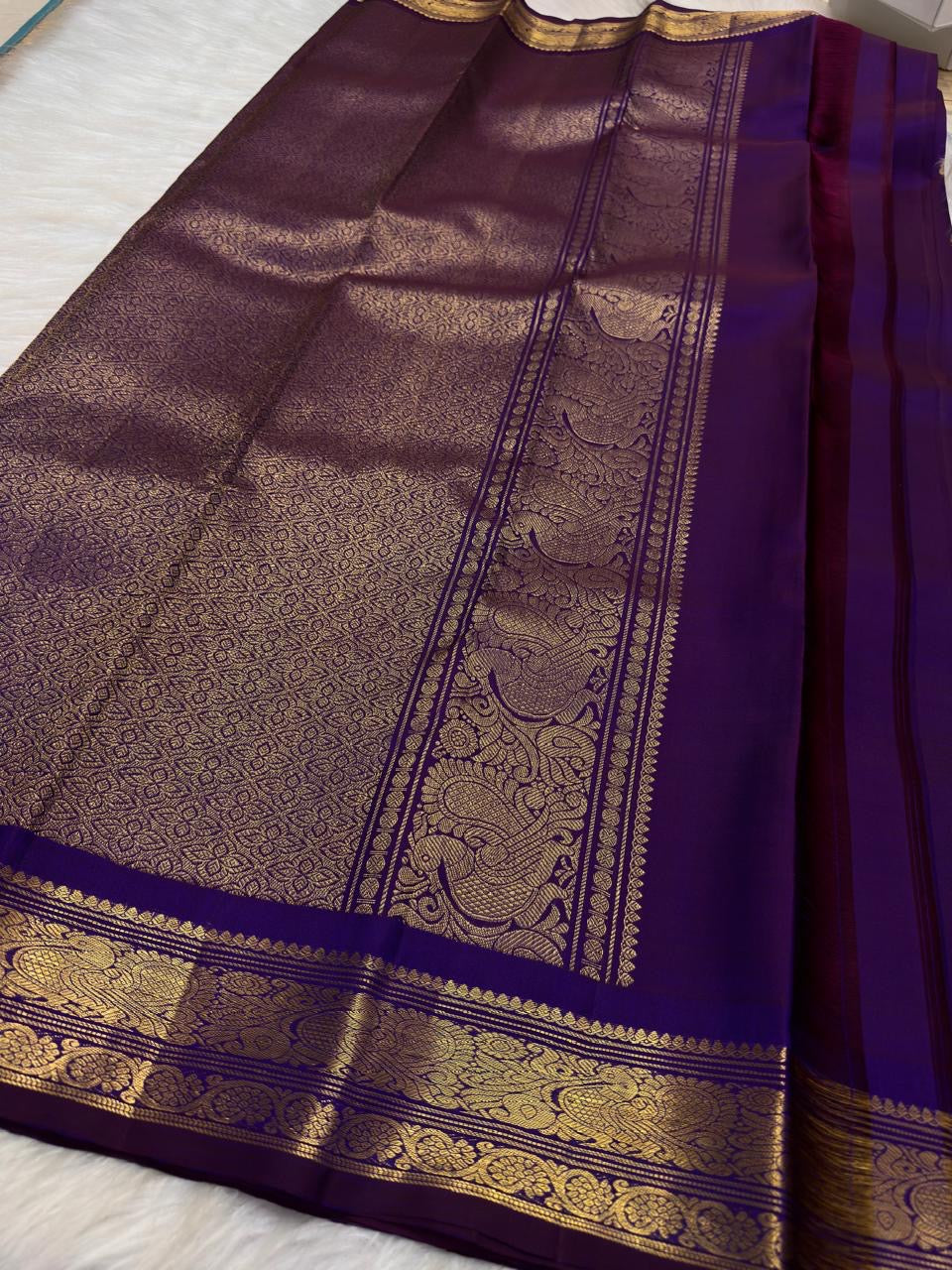 Close view of petite gold zari buttas across Deep Violet Purple pure mulberry silk saree.