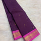 Handwoven Butta KanchiPattu saree in deep violet with small gold zari motifs across the body.