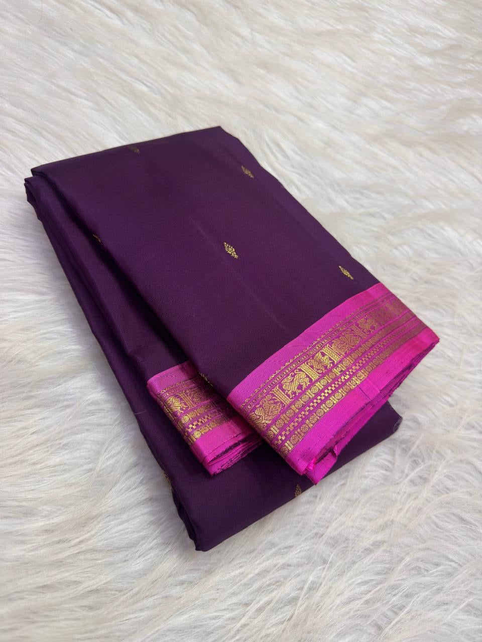 Deep violet Pure Silk KanchiPattu saree with small gold zari buttas and a vivid Fuchsia Pink zari border.