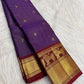 Deep Violet Pure Silk Kanchipuram Vaira saree with petite gold buttas and Arakku Red Yazhi zari border.
