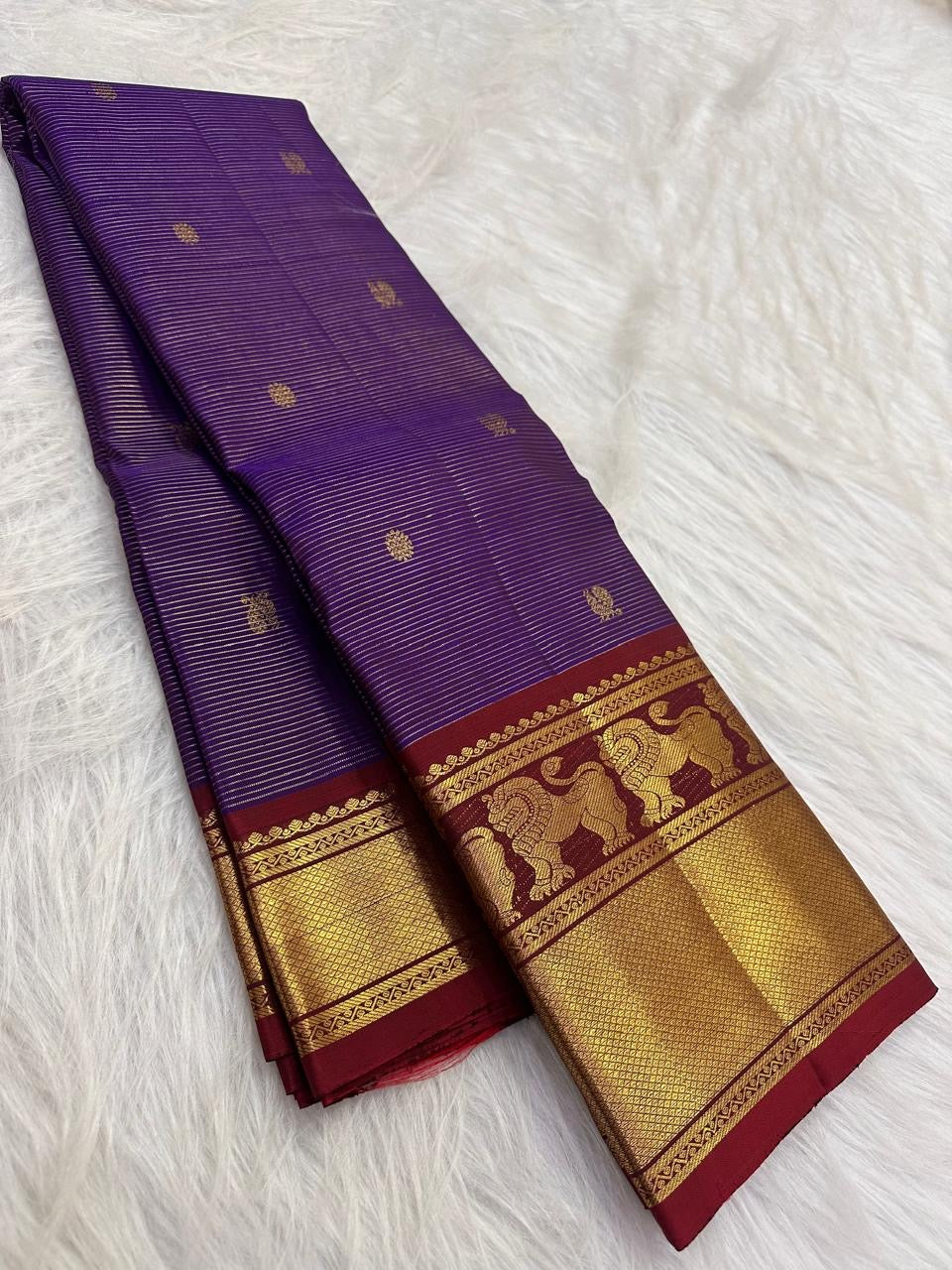Deep Violet Pure Silk Kanchipuram Vaira saree with petite gold buttas and Arakku Red Yazhi zari border.