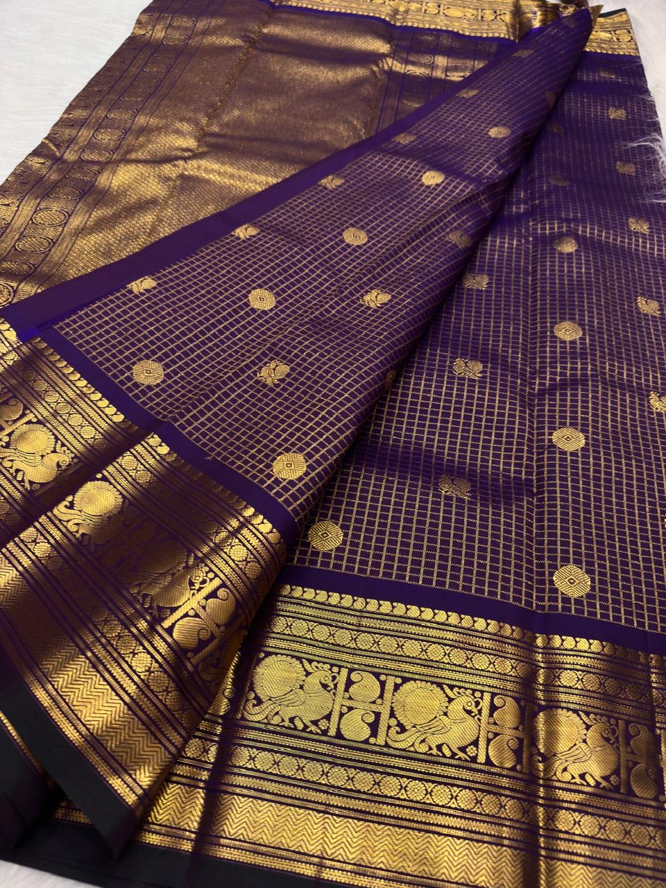 Violet Kanjeevaram saree with standing Yazhi gold zari motifs