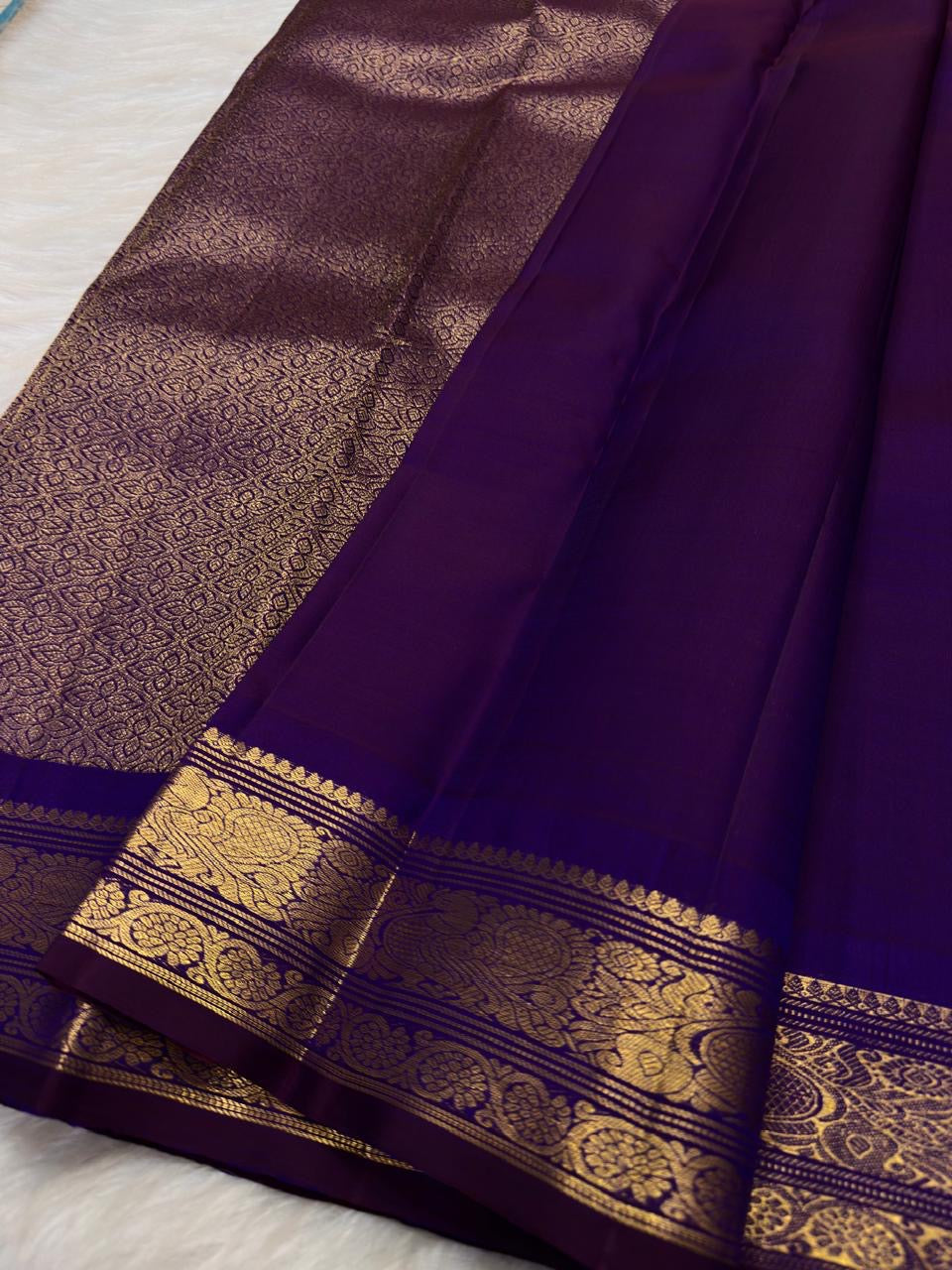 Deep Violet Kanchipuram silk saree with small individually spaced handwoven gold zari buttas.
