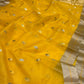 Detail of the turmeric yellow Chanderi silk with small pale and green-accented buttas