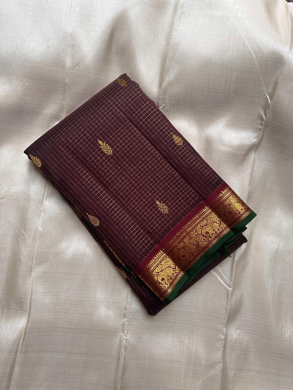 Dense silk Kanjivaram saree with smooth sheen and emerald selvedge