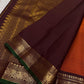 Close view of deep maroon pallu with intricate zari woven design and a wide zari woven border panel with green edge finish.