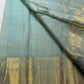 Dewdrop sage green Kanjeevaram saree showing Mayil and Kamalam zari buttas throughout.