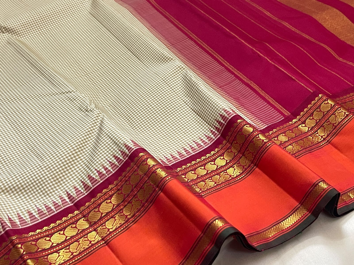 Gold zari diamond-check pallu detail on a biscuit beige and deep pink Kanchipuram silk saree