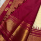 Tomato red pallu section with gold zari woven bands and diamond-style zari pattern near the border on a Kanchipuram silk saree.