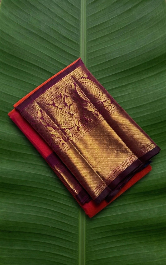 Kanchipuram silk saree in double shade tomato red with hot pink plum purple border border Korvai weave folded view