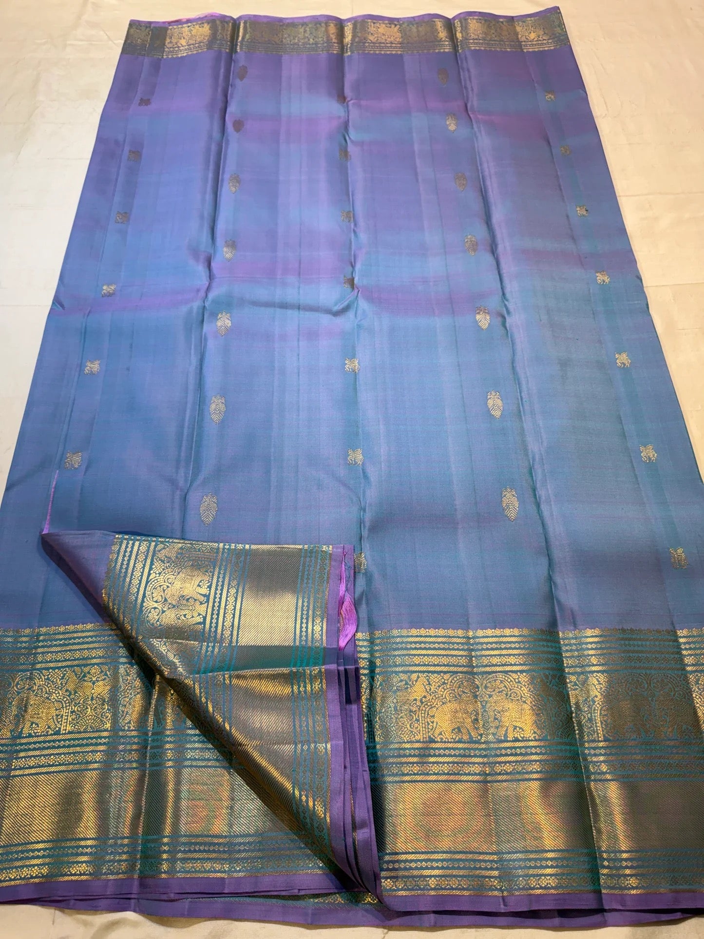 Turquoise blue yali-motif border on Twilight Periwinkle Kanjivaram silk saree
