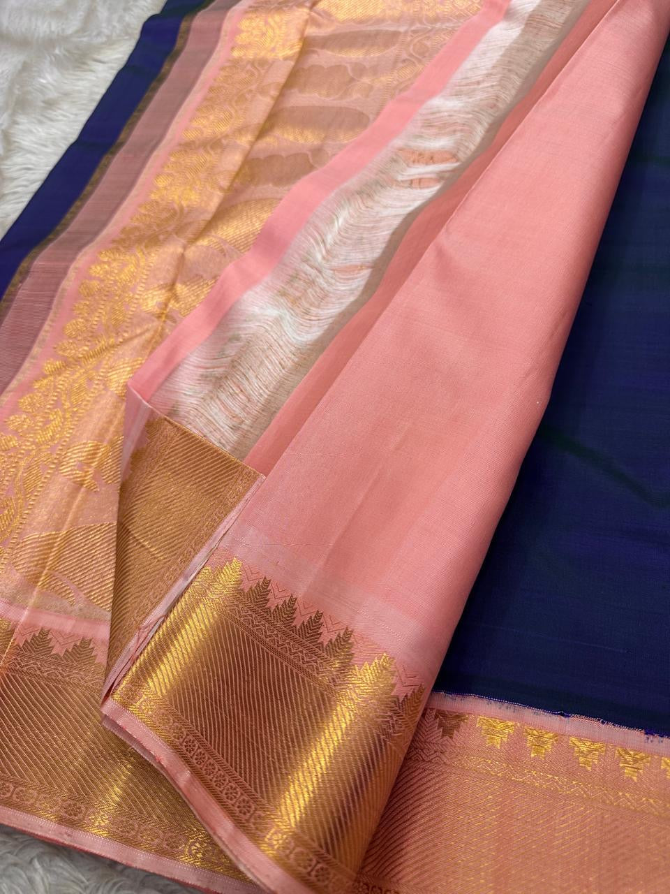 Peach pallu and blush pink border detail on Kanchipuram silk saree with gold zari woven pattern