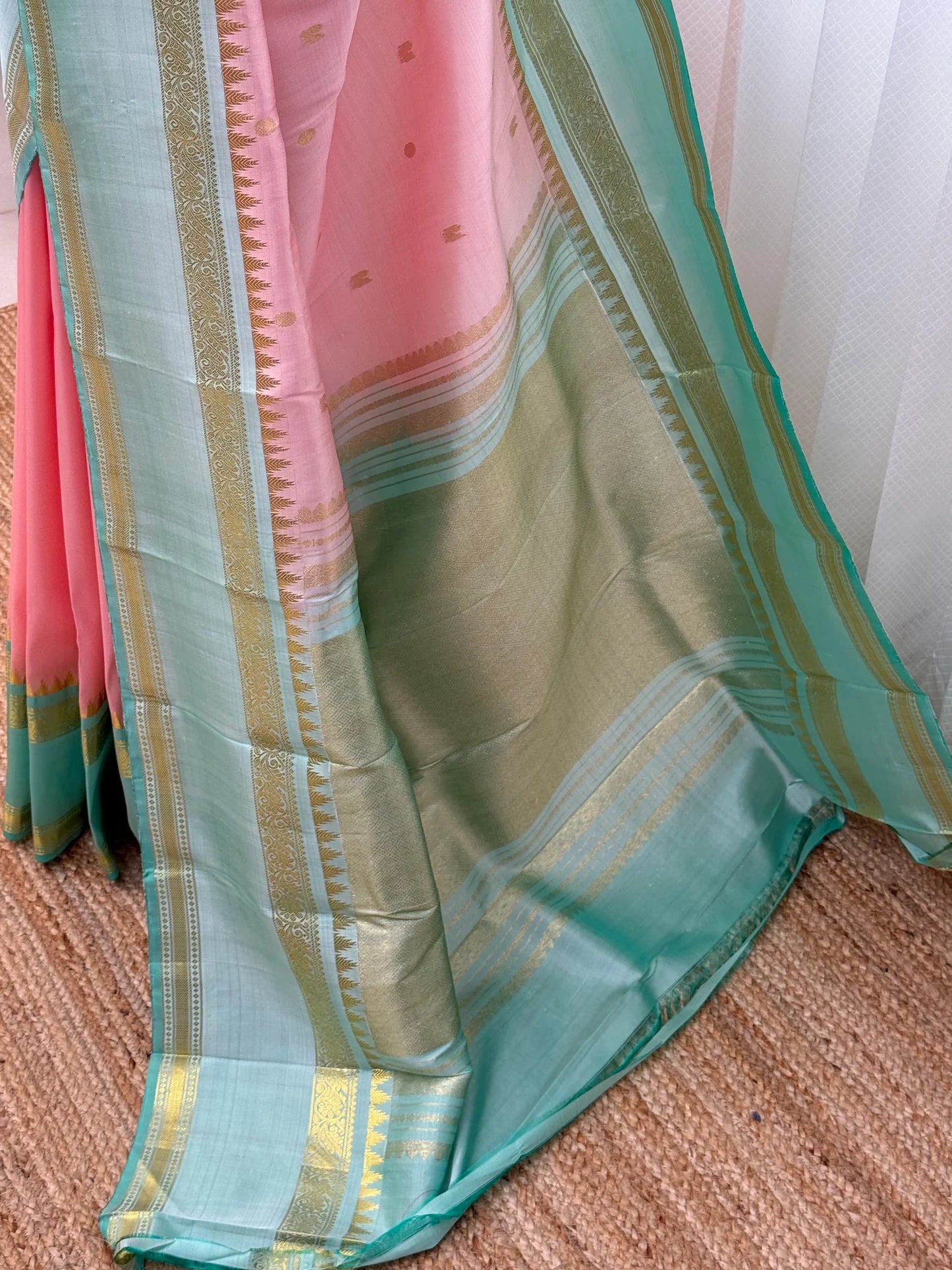 full length drape of pink and sea green kanchipuram silk saree on mannequin