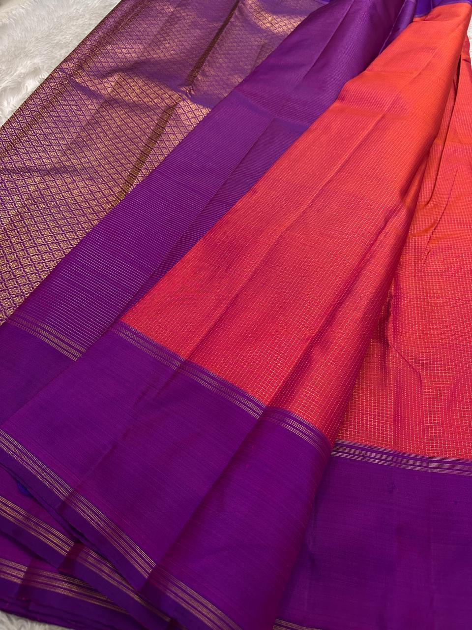 coral red pink silk body with fine checked texture and purple border pure kanchipuram silk saree