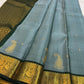 Aqua blue Kanchipuram silk saree with petite gold buttas and handwoven zari paisley motifs
