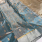 Dusty blue Tissue Pattu Silk Chanderi displayed with silver border, fine gold edging and metallic woven pallu