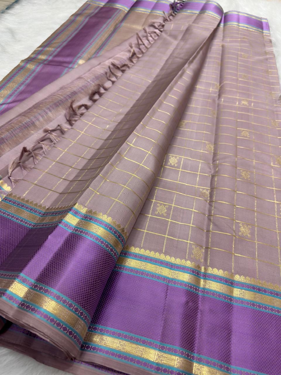 Lavender-purple border detail, dusty-lilac Kanjivaram saree
