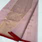 Close-up of antique-gold buttas scattered across the Dusty Rose Chanderi saree body