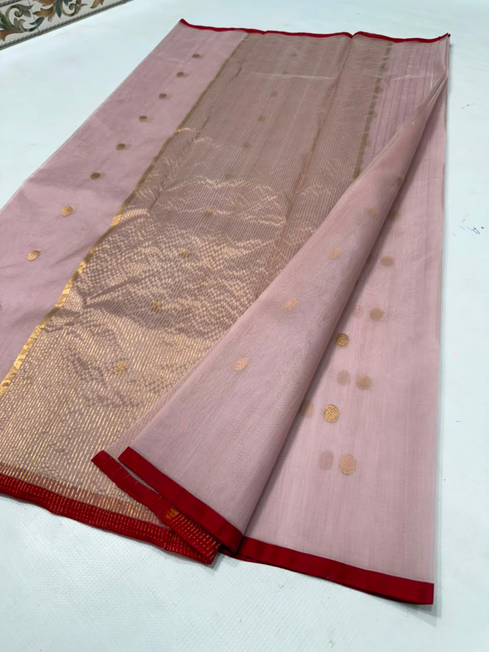 Close-up of antique-gold buttas scattered across the Dusty Rose Chanderi saree body