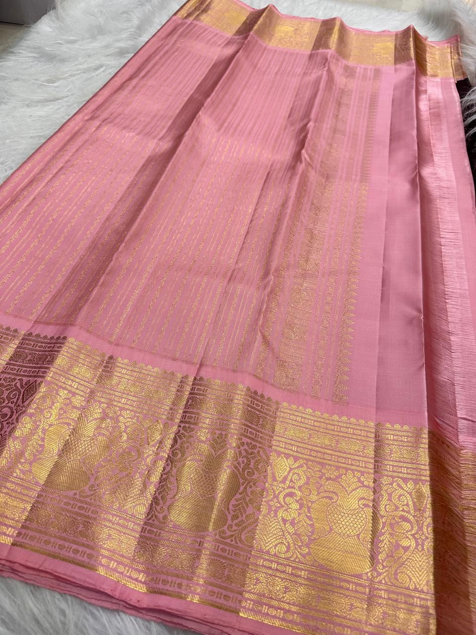 Dusty Rose Pink and gold Korvai border on a handwoven Deep Aubergine Brown Kanchi Pattu saree.