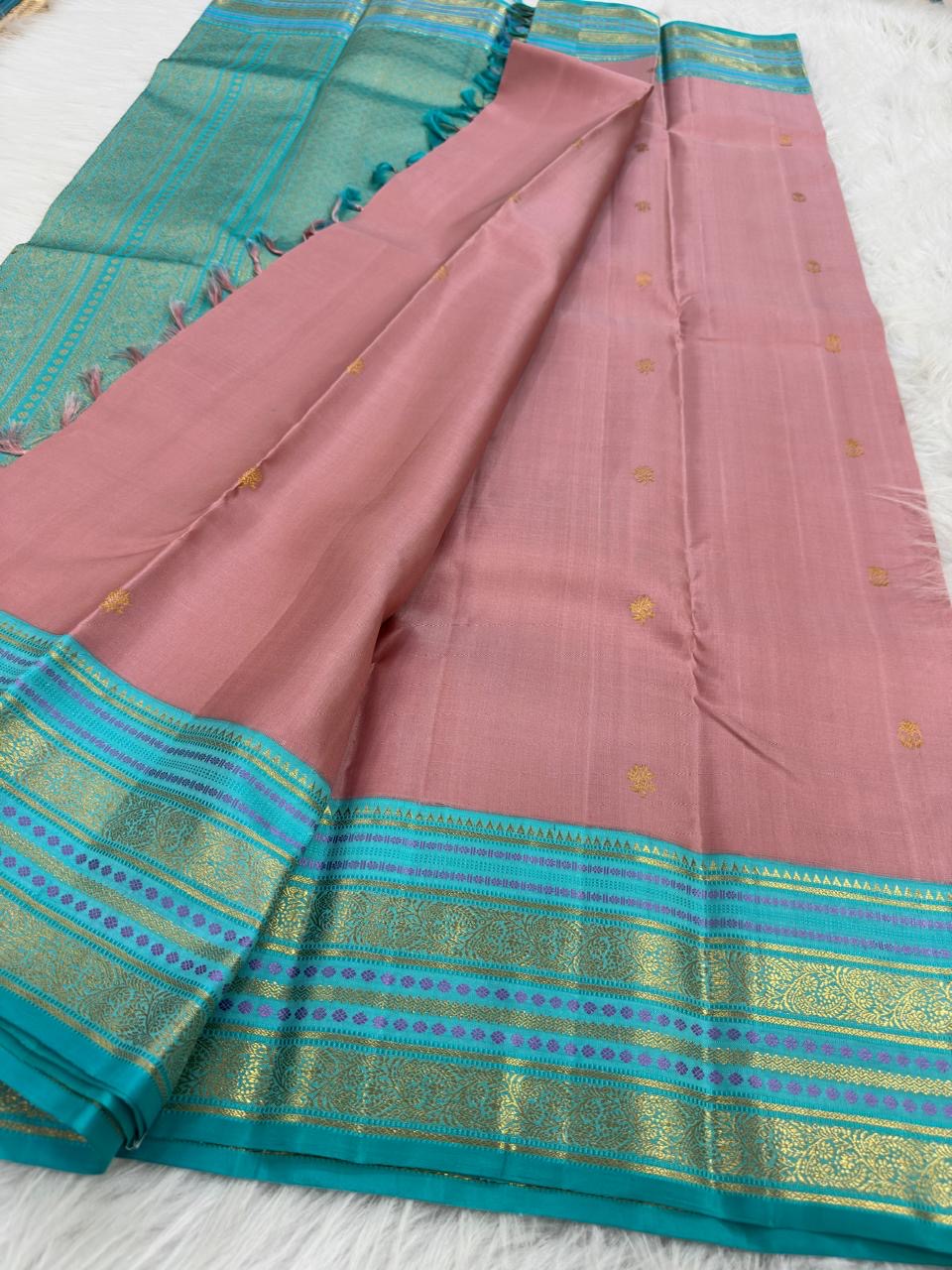 Close-up of dusty rose pure mulberry silk body with gold zari butta motifs, Kanjipuram Varisaipet saree