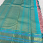 Close-up of turquoise Varisaipet border with gold zari motifs on Kanjipuram silk saree