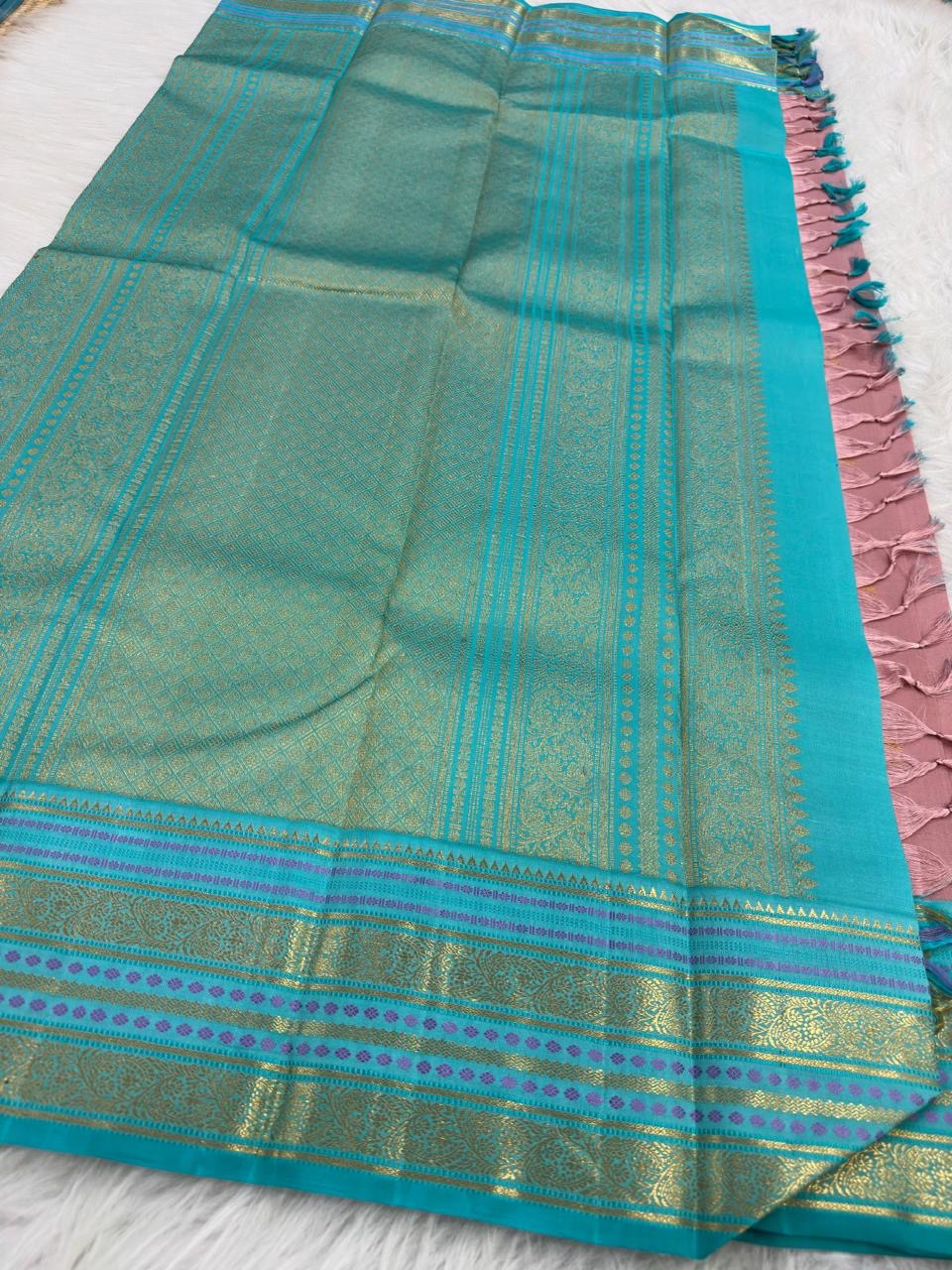 Close-up of turquoise Varisaipet border with gold zari motifs on Kanjipuram silk saree
