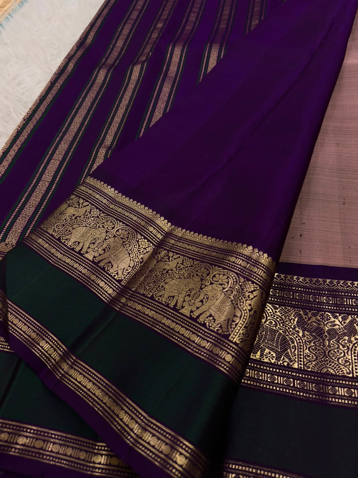 Dusty Rose Taupe Kanchi Pattu Saree — royal-purple border with gold zari elephant and ornamental motifs
