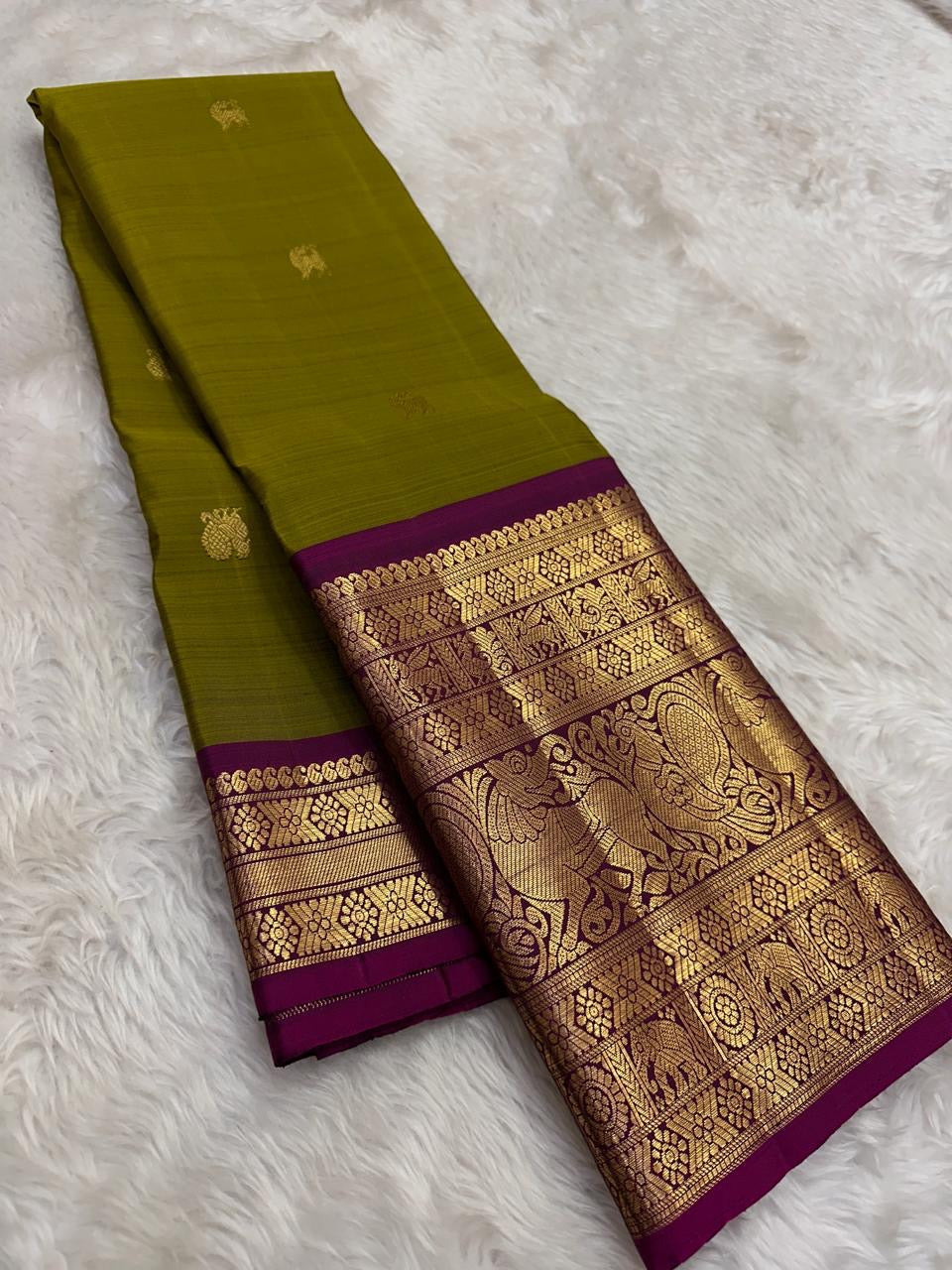 Handwoven Kanjeevaram saree featuring betel leaf green body with heritage Yazhi butta weaving