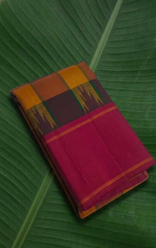 Earthy mustard yellow Kanchipuram silk saree with saffron arakku checks and kumkum pink border.