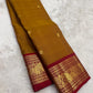 Kanchipattu silk saree in korvai with earthy mustard yellow border weave traditional zari detail