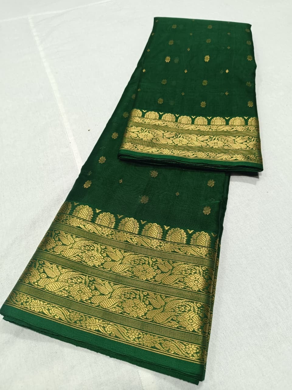 Emerald Green Chanderi Katan Silk saree folded to show the silk's luminous surface